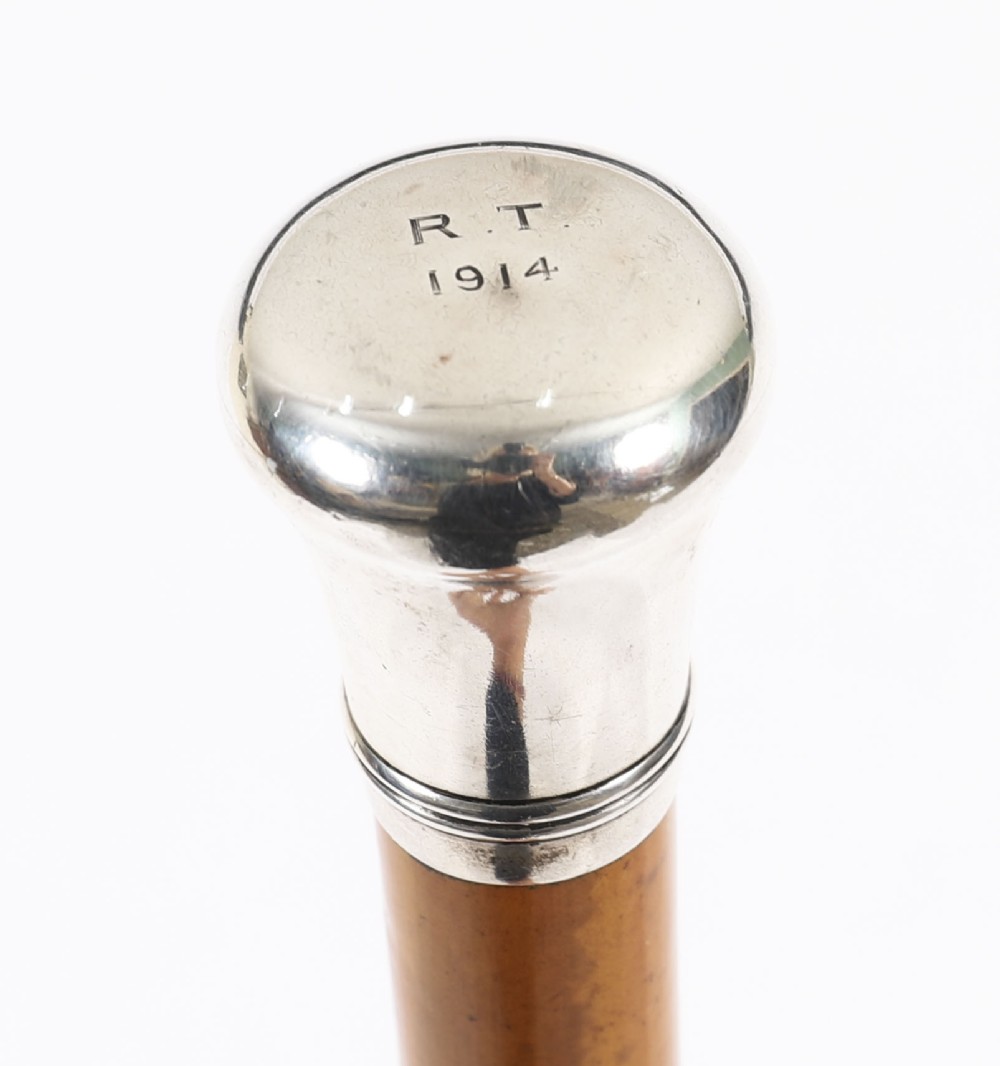 An Edwardian walking stick featuring a smooth domed sterling silver pommel and a polished wooden shaft. View III