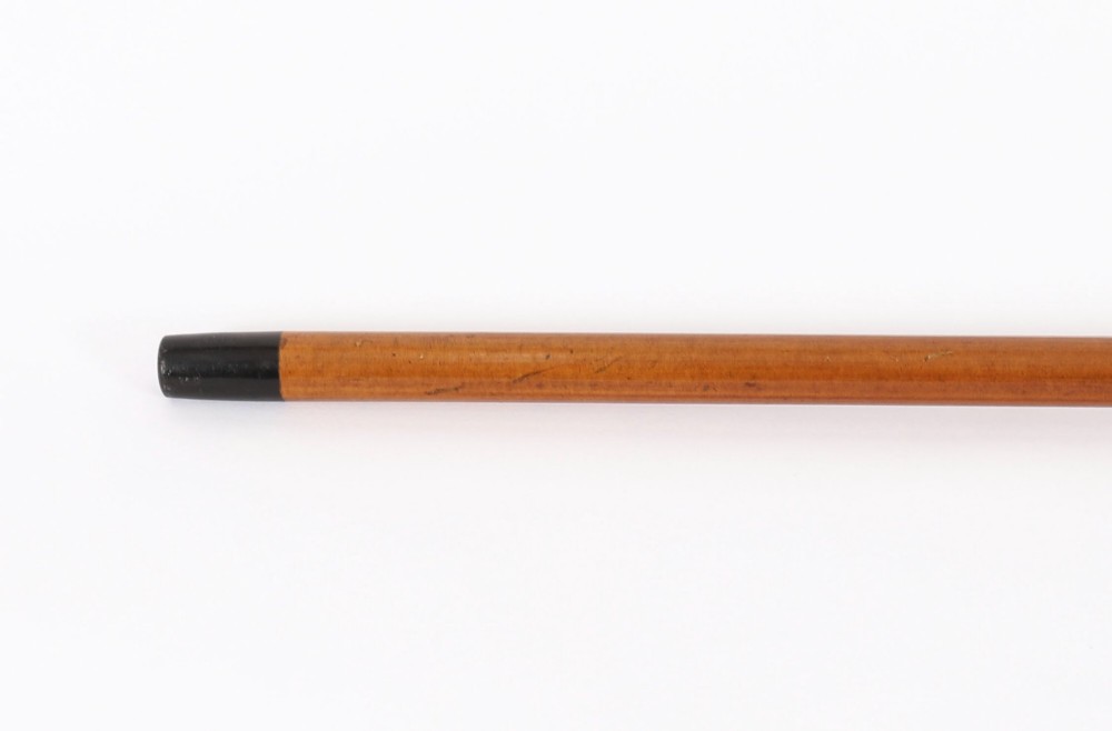 An Edwardian walking stick featuring a smooth domed sterling silver pommel and a polished wooden shaft. View X