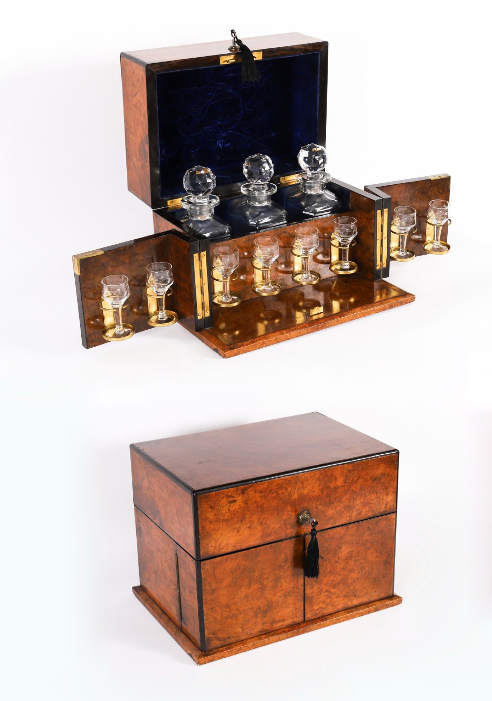 An open and closed 19th-century Victorian burr walnut tantalus box containing three cut crystal decanters, brass-mounted liqueur glasses, and a deep blue velvet lining.