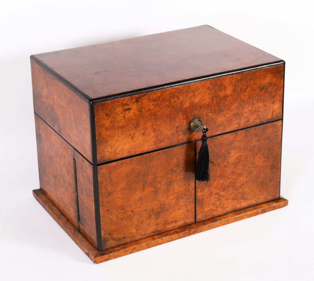 An open and closed 19th-century Victorian burr walnut tantalus box containing three cut crystal decanters, brass-mounted liqueur glasses, and a deep blue velvet lining. View VII