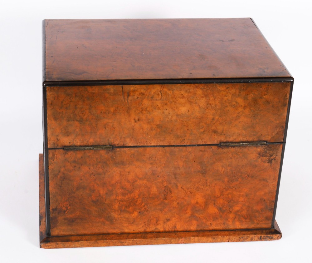 An open and closed 19th-century Victorian burr walnut tantalus box containing three cut crystal decanters, brass-mounted liqueur glasses, and a deep blue velvet lining. View IX