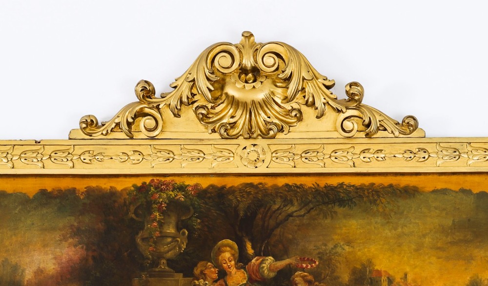 An antique French giltwood trumeau mirror with a painted pastoral scene top panel, carved shell cresting, and three glass mirror sections. View III