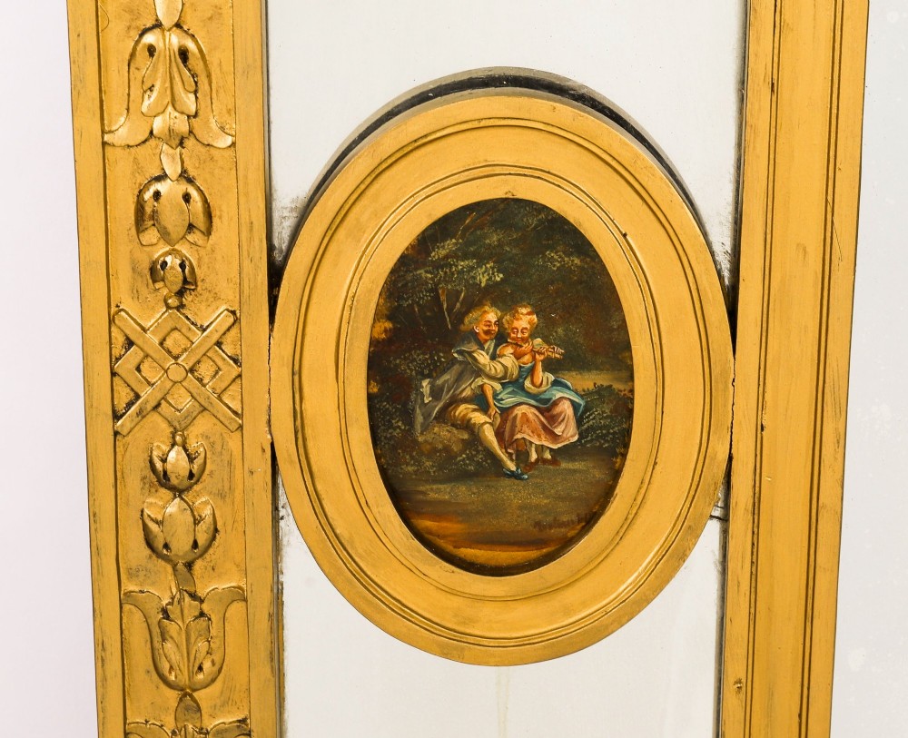 An antique French giltwood trumeau mirror with a painted pastoral scene top panel, carved shell cresting, and three glass mirror sections. View X