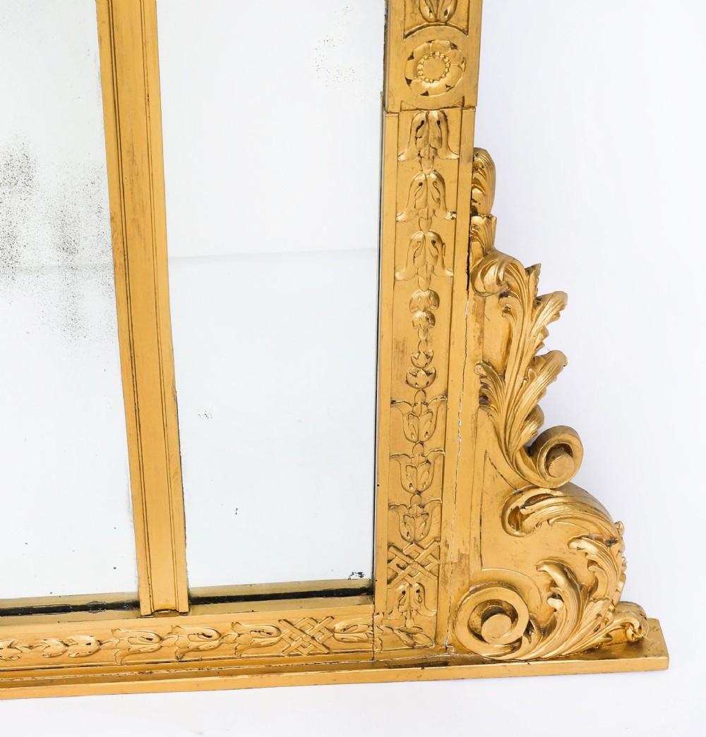 An antique French giltwood trumeau mirror with a painted pastoral scene top panel, carved shell cresting, and three glass mirror sections. View XII