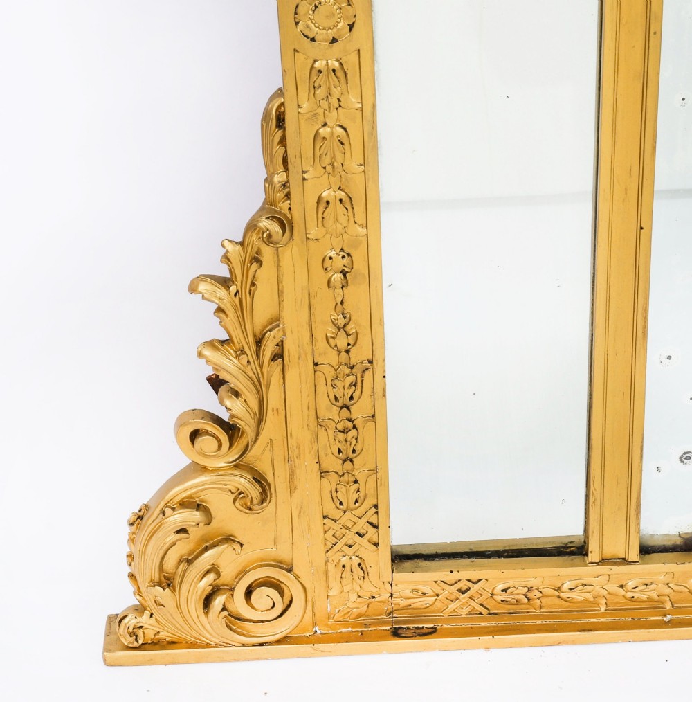 An antique French giltwood trumeau mirror with a painted pastoral scene top panel, carved shell cresting, and three glass mirror sections. View XIII