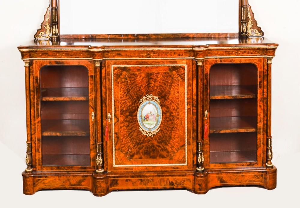 A nineteenth-century Victorian burr walnut credenza featuring an arched mirror back, glazed side doors, and a central cupboard inlaid with a porcelain plaque. View II