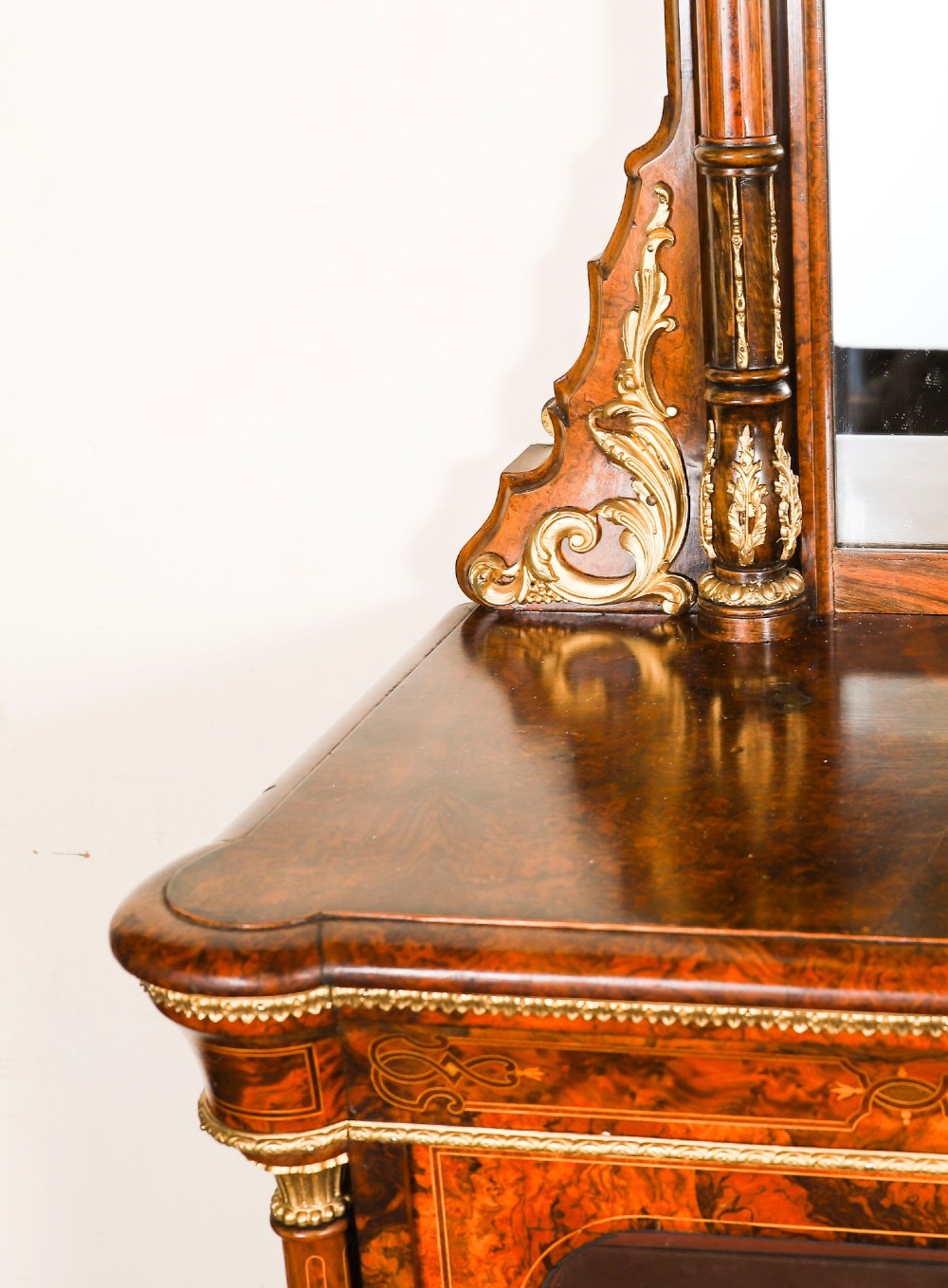 A nineteenth-century Victorian burr walnut credenza featuring an arched mirror back, glazed side doors, and a central cupboard inlaid with a porcelain plaque. View IV