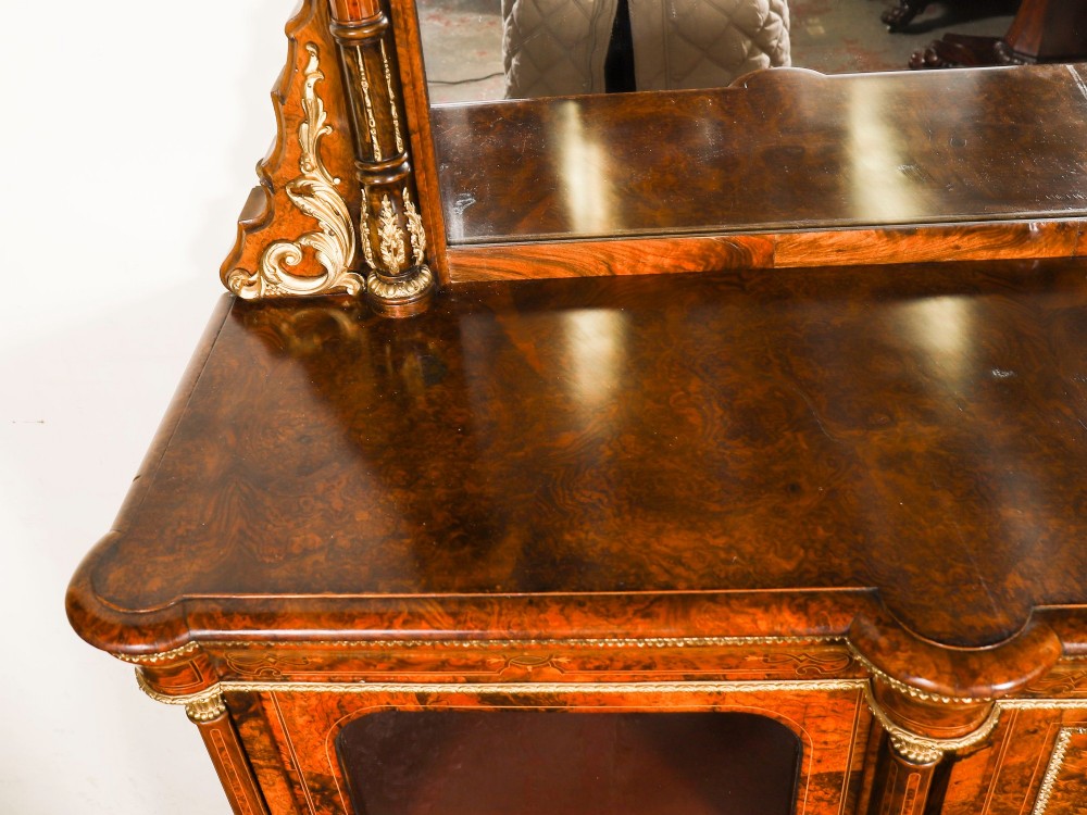 A nineteenth-century Victorian burr walnut credenza featuring an arched mirror back, glazed side doors, and a central cupboard inlaid with a porcelain plaque. View V