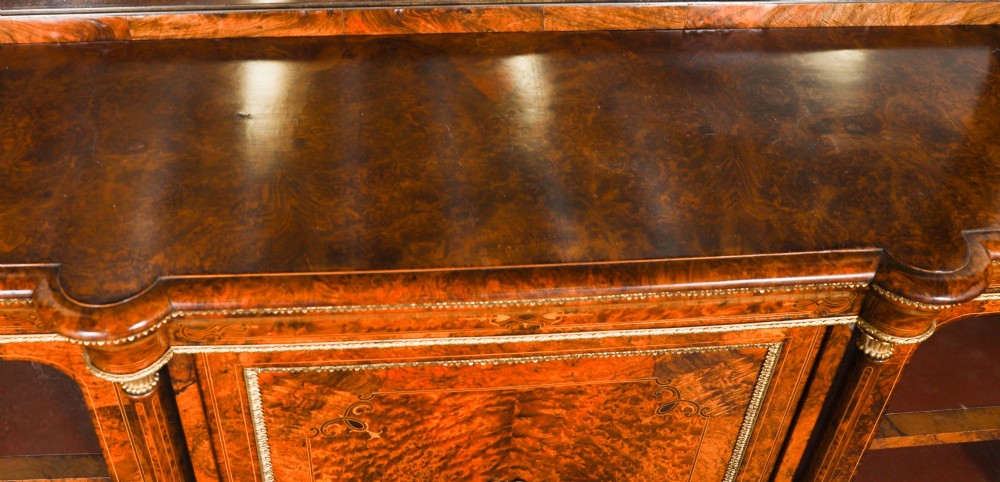 A nineteenth-century Victorian burr walnut credenza featuring an arched mirror back, glazed side doors, and a central cupboard inlaid with a porcelain plaque. View VII