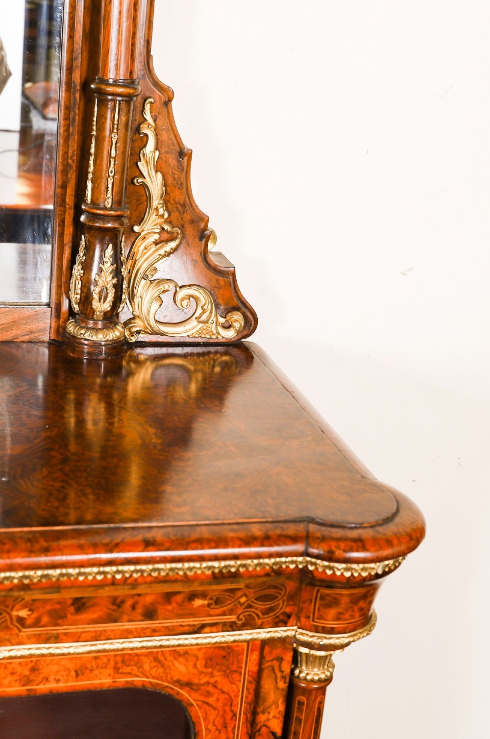 A nineteenth-century Victorian burr walnut credenza featuring an arched mirror back, glazed side doors, and a central cupboard inlaid with a porcelain plaque. View VIII