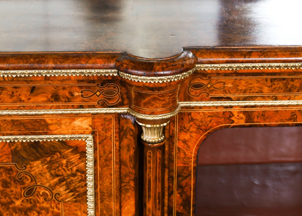 A nineteenth-century Victorian burr walnut credenza featuring an arched mirror back, glazed side doors, and a central cupboard inlaid with a porcelain plaque. View IX