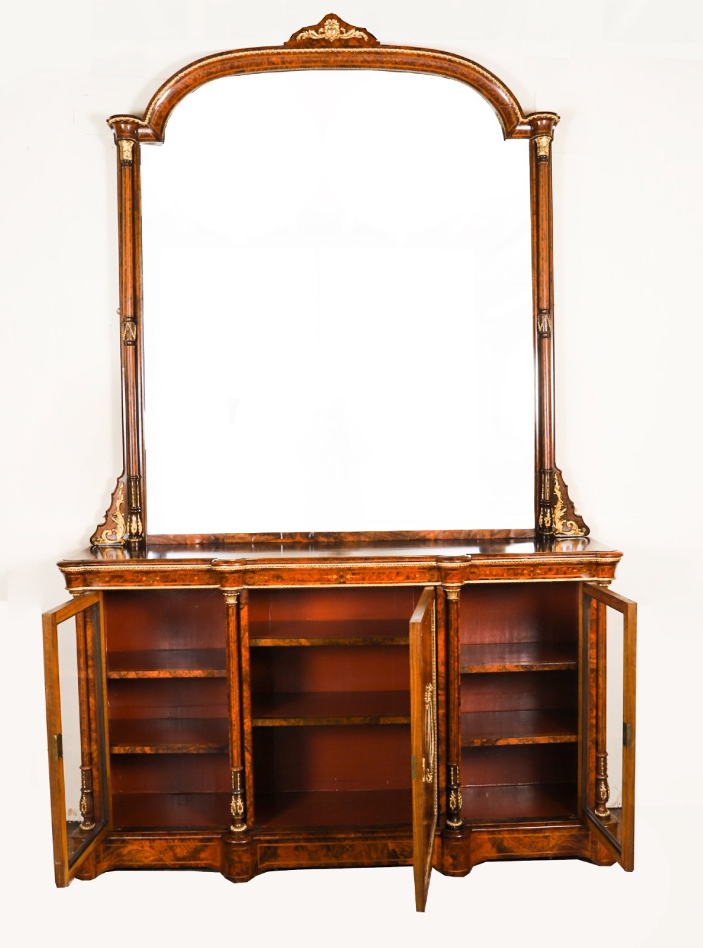 A nineteenth-century Victorian burr walnut credenza featuring an arched mirror back, glazed side doors, and a central cupboard inlaid with a porcelain plaque. View XIV