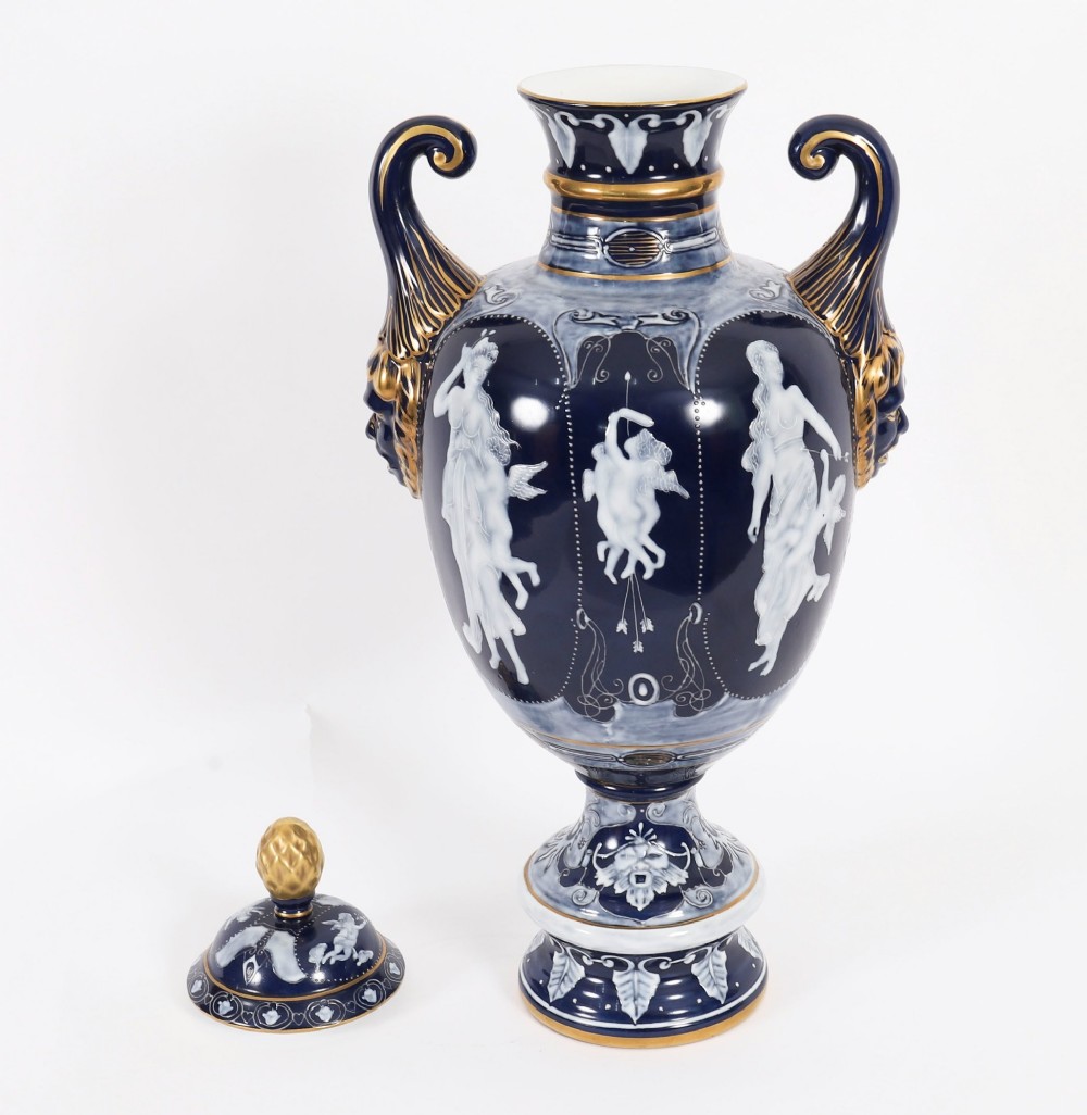 A pair of cobalt blue and white porcelain lidded vases featuring classical figures, scrolling handles, and gilded finials. View III