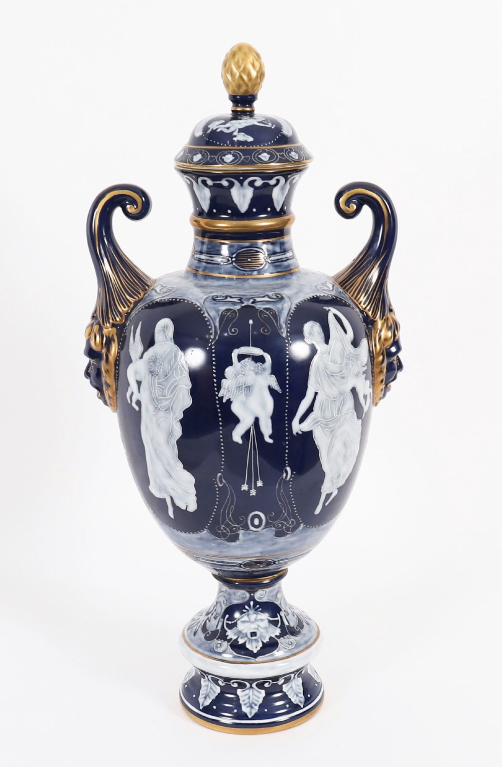 A pair of cobalt blue and white porcelain lidded vases featuring classical figures, scrolling handles, and gilded finials. View XI