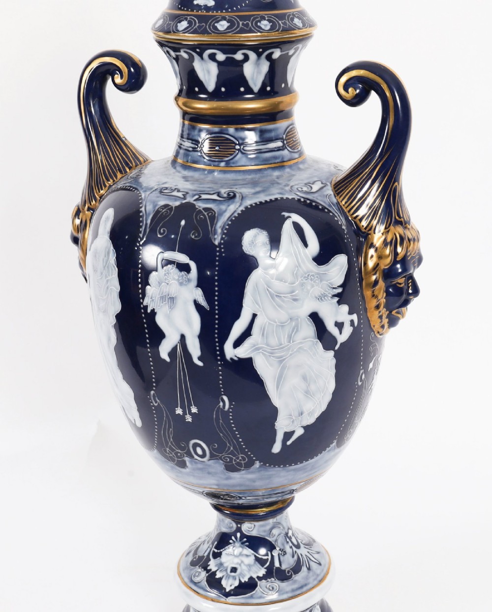 A pair of cobalt blue and white porcelain lidded vases featuring classical figures, scrolling handles, and gilded finials. View XIII