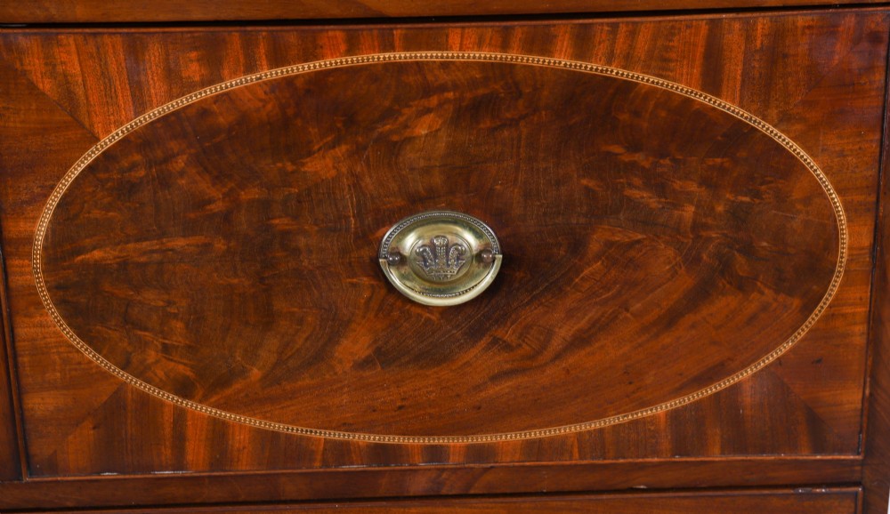 An antique George III flame mahogany secretaire bookcase featuring a shaped pediment, two upper astragal glazed doors, and a lower four-drawer chest base with brass ring handles. View VII
