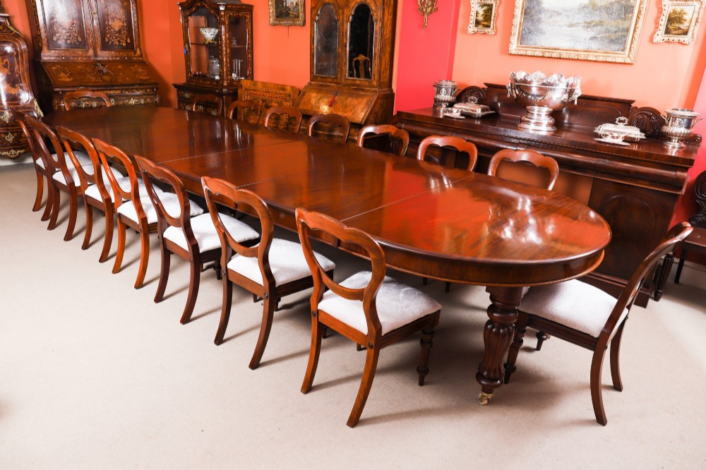 A large George III extending dining table in Cuban flame mahogany with turned fluted legs and brass castors. View V