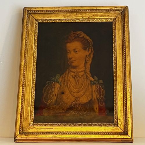 fig 1. An 18th-century reverse glass portrait depicting Queen Charlotte wearing lace and pearls, housed inside a carved giltwood frame.