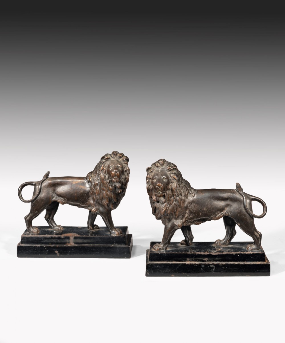 Pair of early Nineteenth Century Regency cast iron lion sculptures.