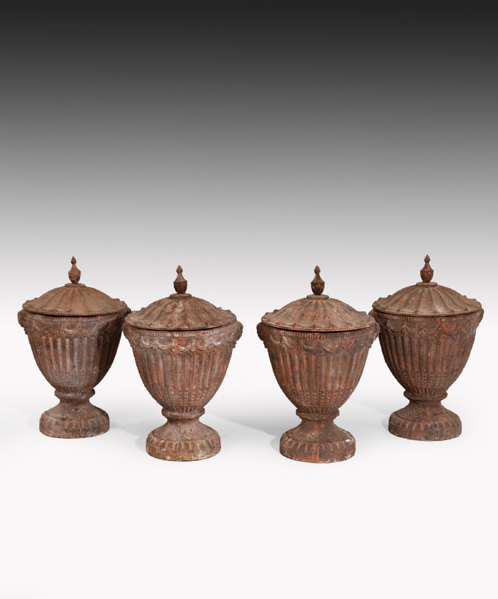 Set of Four Nineteenth Century cast iron garden urns.