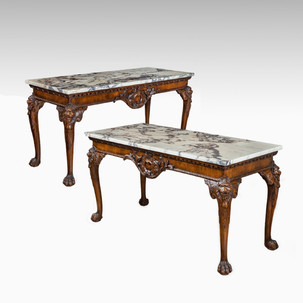 Pair of George II style carved mahogany console tables.