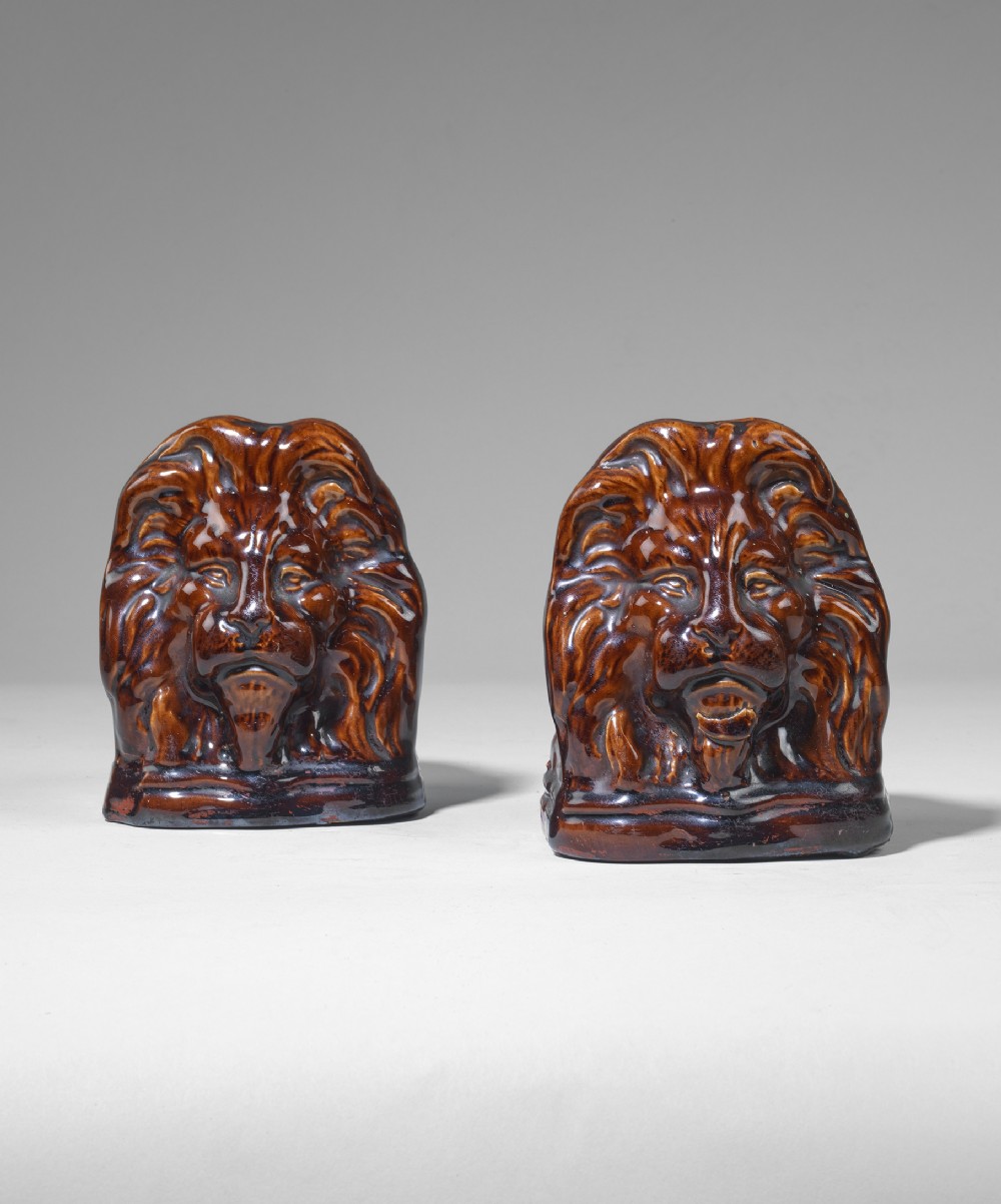 Pair of mid Nineteenth Century ceramic lion sash stops