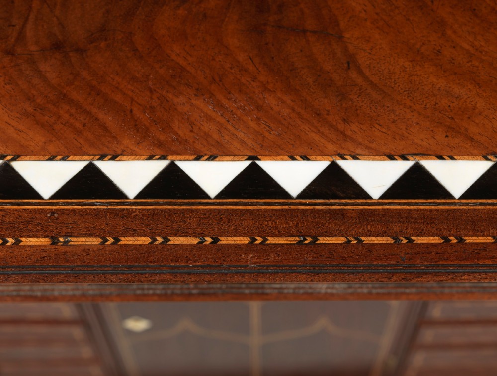 A mid-18th century Chippendale mahogany collectors cabinet on stand featuring diamond bone inlays, delicate line decoration, and two panelled doors. View XIII