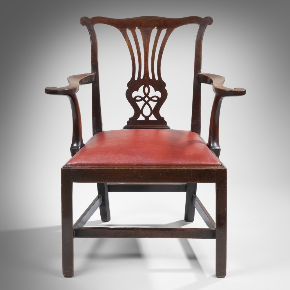 A pair of Chippendale style mahogany armchairs featuring pierced back splats, curved armrests, and red leather seats. View III