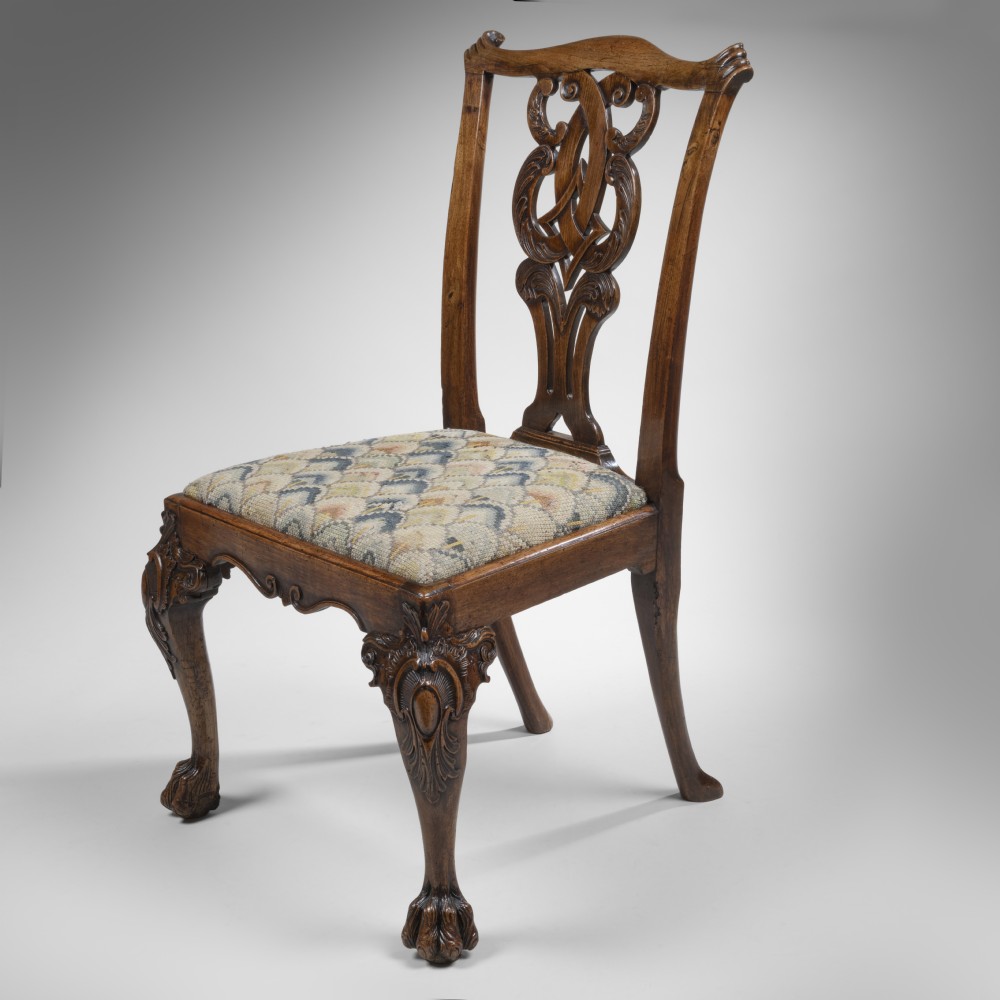A pair of 18th-century George II carved walnut side chairs with decorative pierced back splats, pattern-upholstered drop-in seats, and cabriole legs with claw-and-ball feet. View III