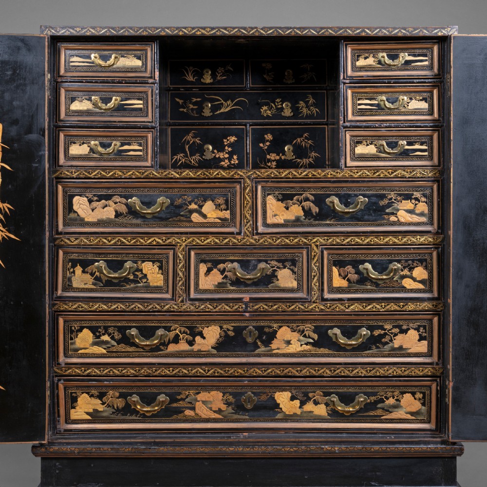 A 19th-century Chinese black lacquer cabinet decorated with intricate gilt landscapes, mounted on a matching tall table stand. View II