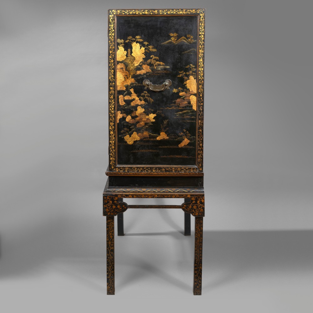 A 19th-century Chinese black lacquer cabinet decorated with intricate gilt landscapes, mounted on a matching tall table stand. View VI