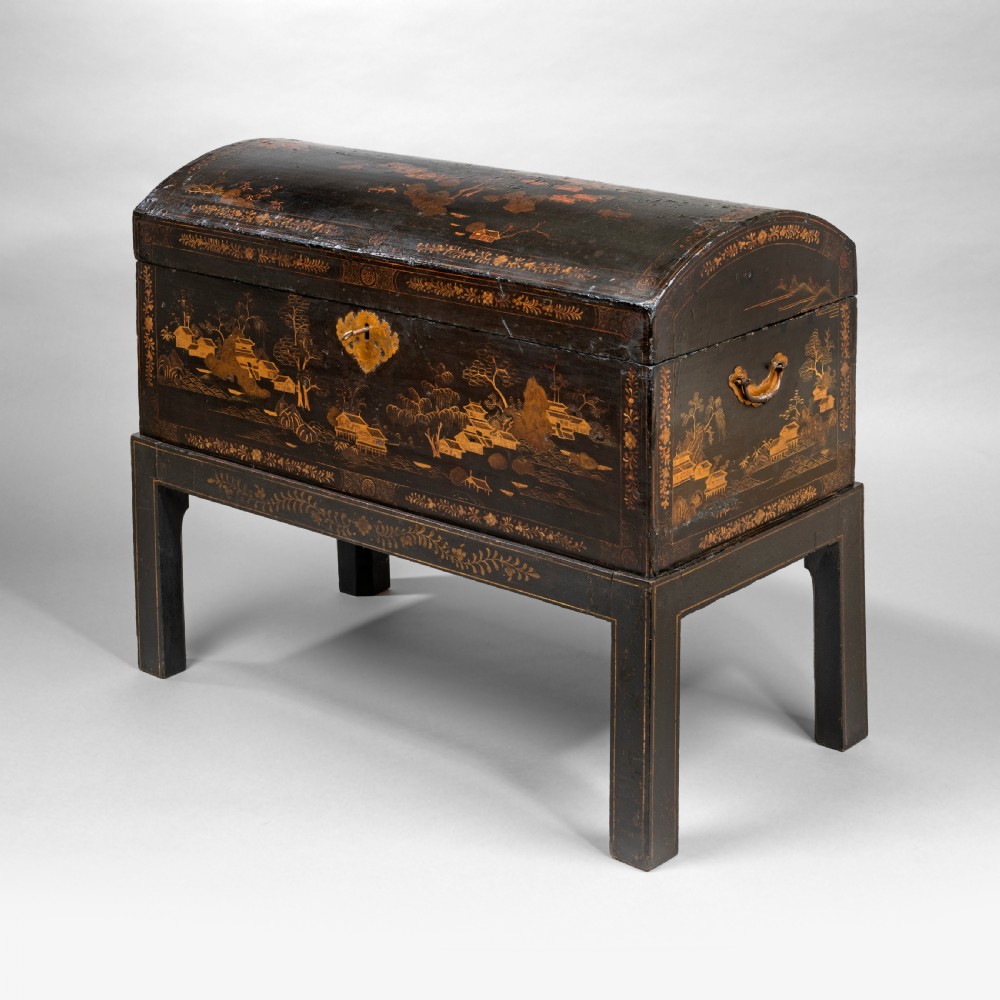 An eighteenth-century black lacquer coffer featuring gold chinoiserie landscape paintings, resting on a matching wooden stand. View IV