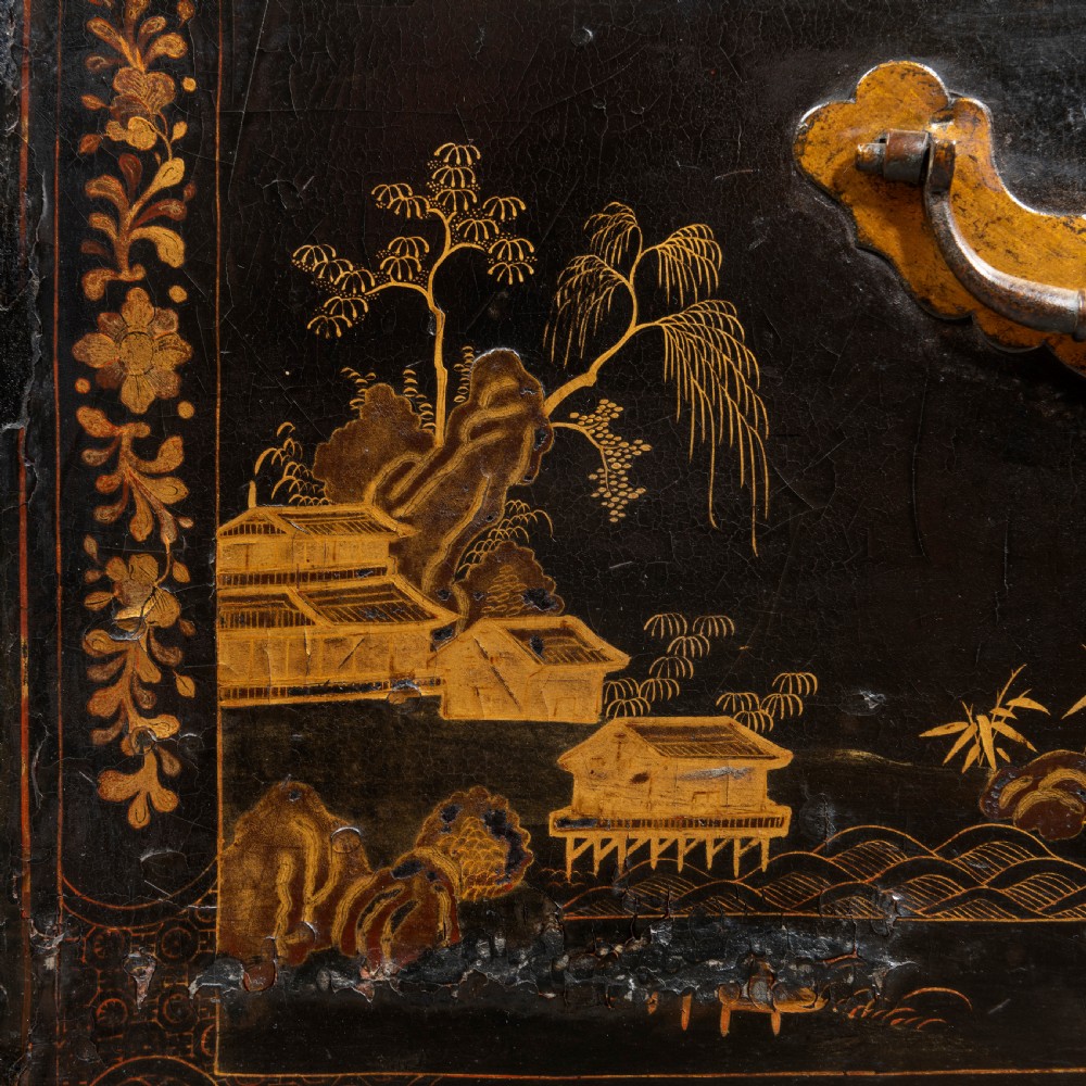 An eighteenth-century black lacquer coffer featuring gold chinoiserie landscape paintings, resting on a matching wooden stand. View VI