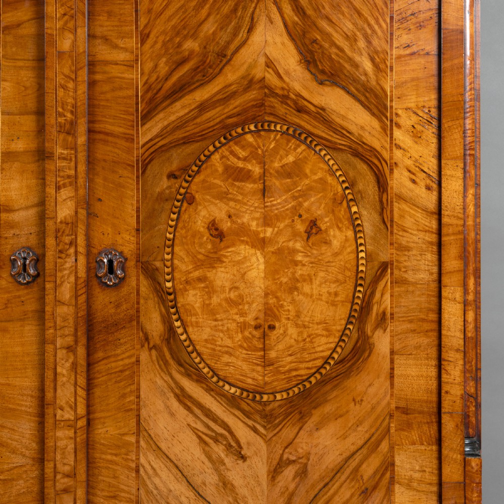 An eighteenth-century walnut bureau bookcase with double panelled doors above a sloping slant-front writing surface and drawers. View IV