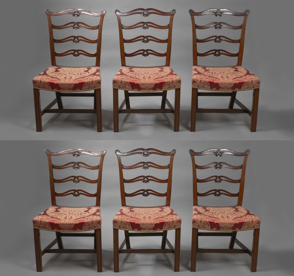 A set of Georgian mahogany ladder-back dining chairs including a carver armchair with red patterned damask upholstery. View II