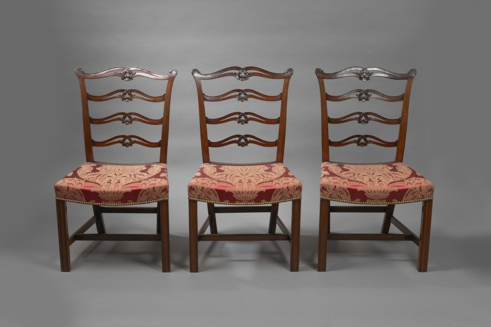 A set of Georgian mahogany ladder-back dining chairs including a carver armchair with red patterned damask upholstery. View III