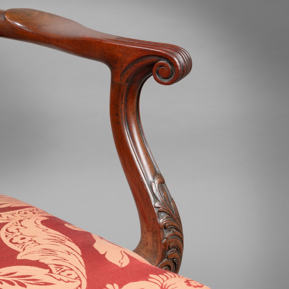 A set of Georgian mahogany ladder-back dining chairs including a carver armchair with red patterned damask upholstery. View IV