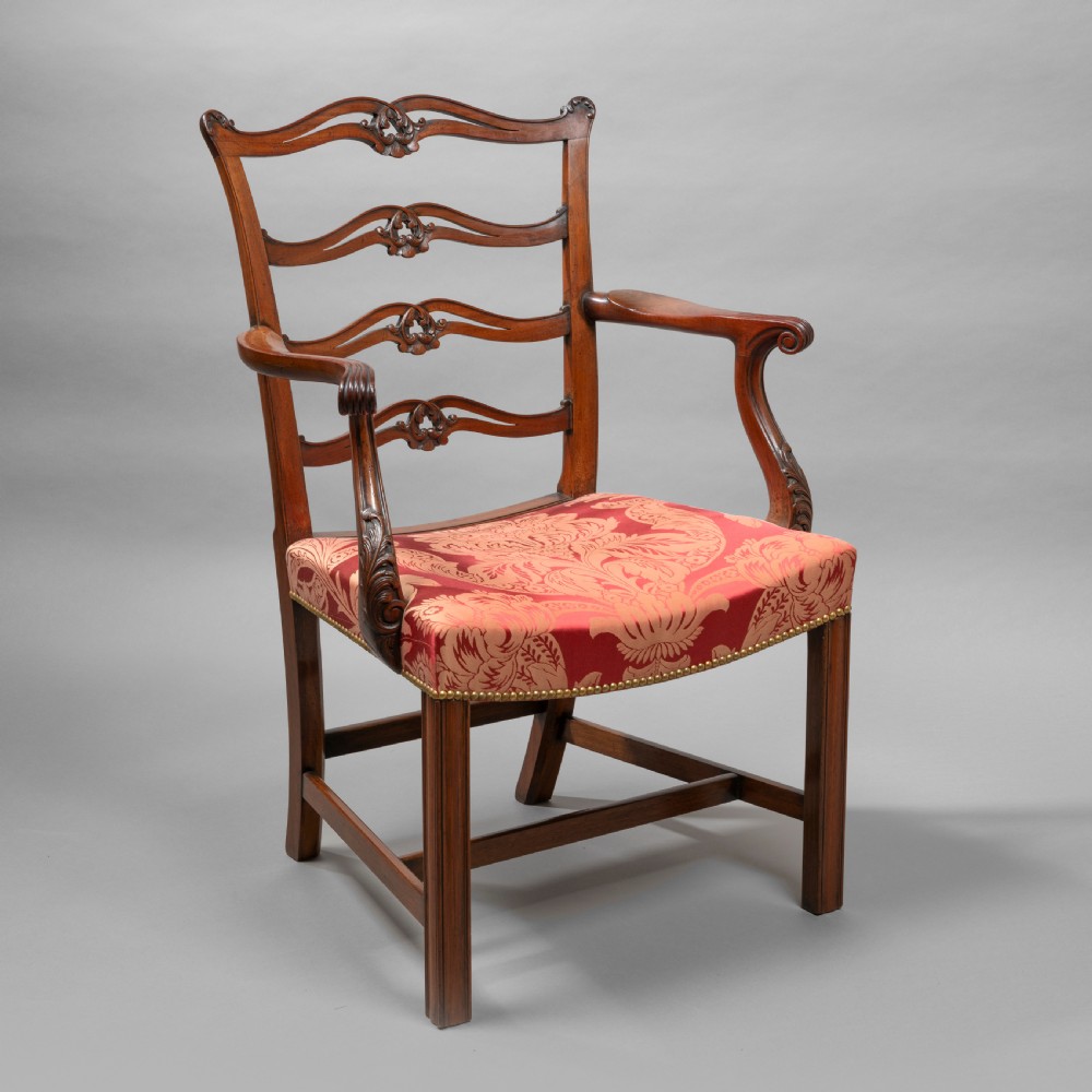 A set of Georgian mahogany ladder-back dining chairs including a carver armchair with red patterned damask upholstery. View VII
