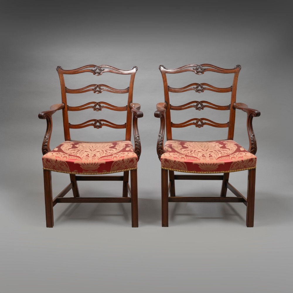 A set of Georgian mahogany ladder-back dining chairs including a carver armchair with red patterned damask upholstery. View VIII