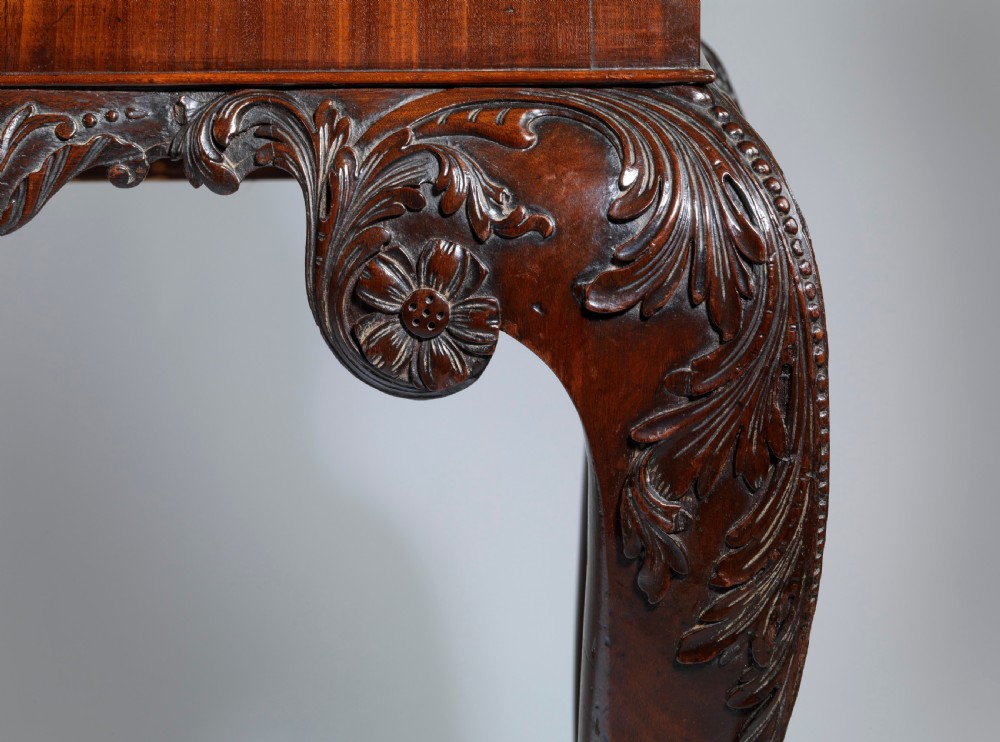 A dark mahogany George II style display cabinet on stand featuring glazed double doors, a carved apron with central mask detail, and cabriole legs with claw and ball feet. View VI