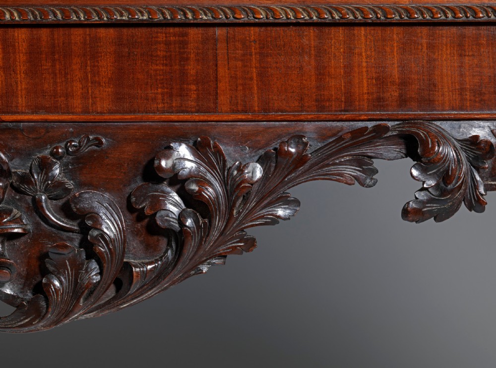 A dark mahogany George II style display cabinet on stand featuring glazed double doors, a carved apron with central mask detail, and cabriole legs with claw and ball feet. View VII