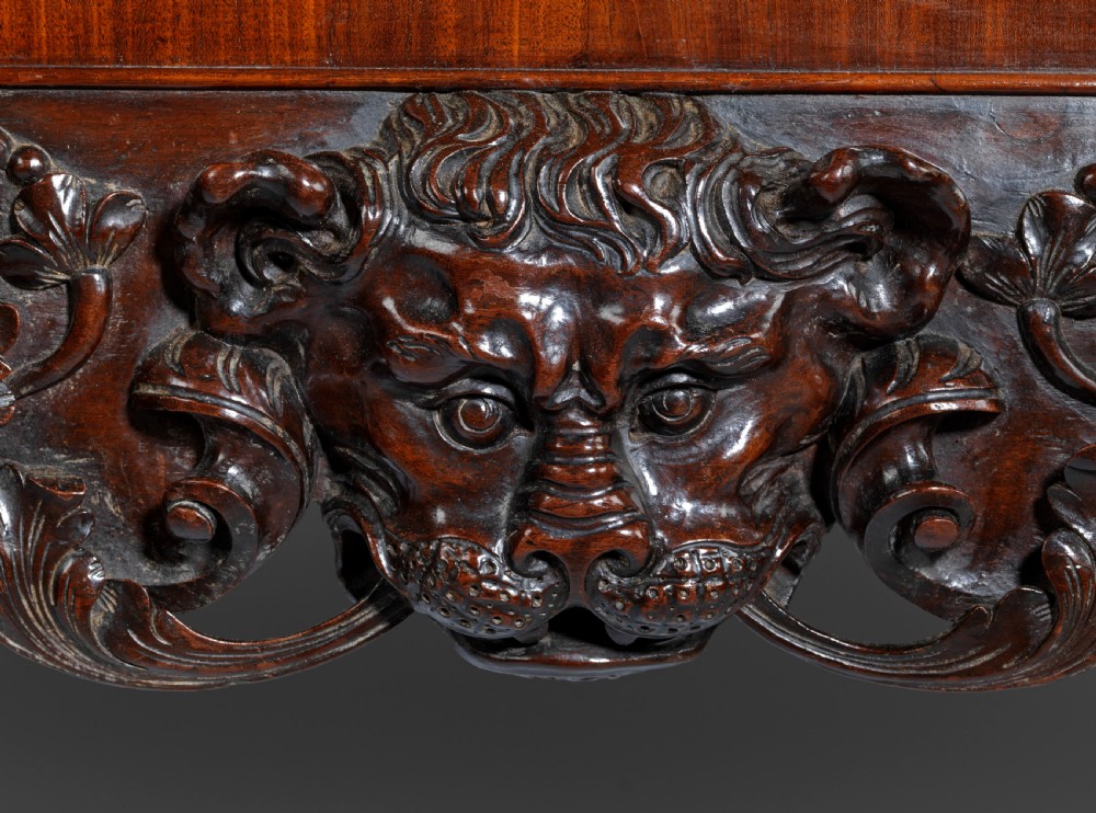 A dark mahogany George II style display cabinet on stand featuring glazed double doors, a carved apron with central mask detail, and cabriole legs with claw and ball feet. View VIII