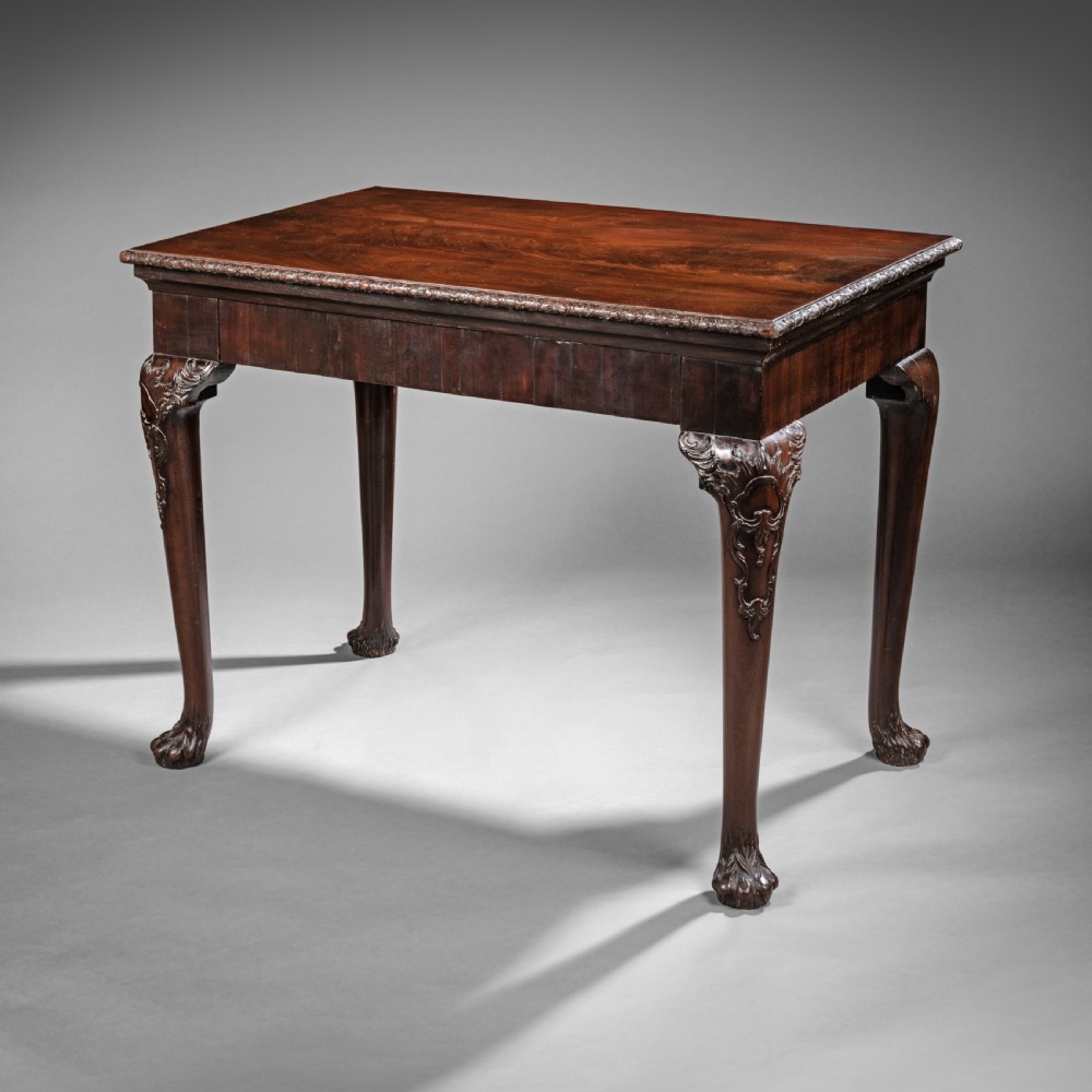An 18th-century Irish George II mahogany console table featuring carved cabriole legs with claw-and-ball feet and a moulded rectangular top.