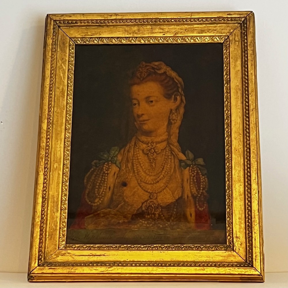 An 18th-century reverse glass portrait depicting Queen Charlotte wearing lace and pearls, housed inside a carved giltwood frame.