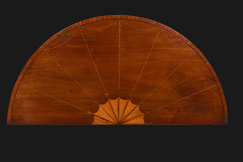 A Georgian mahogany demi-lune console table featuring fan marquetry inlay and tapered square legs. View II