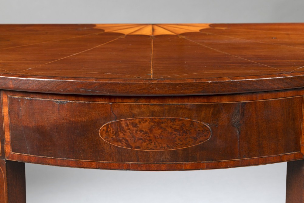 A Georgian mahogany demi-lune console table featuring fan marquetry inlay and tapered square legs. View III