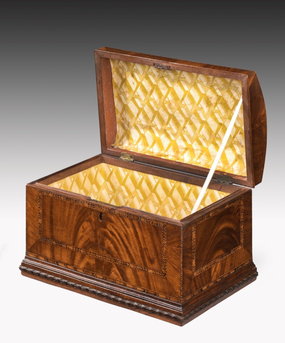 A Georgian mahogany box featuring a domed lid, geometric inlay borders, a top brass handle, and a front keyhole. View II
