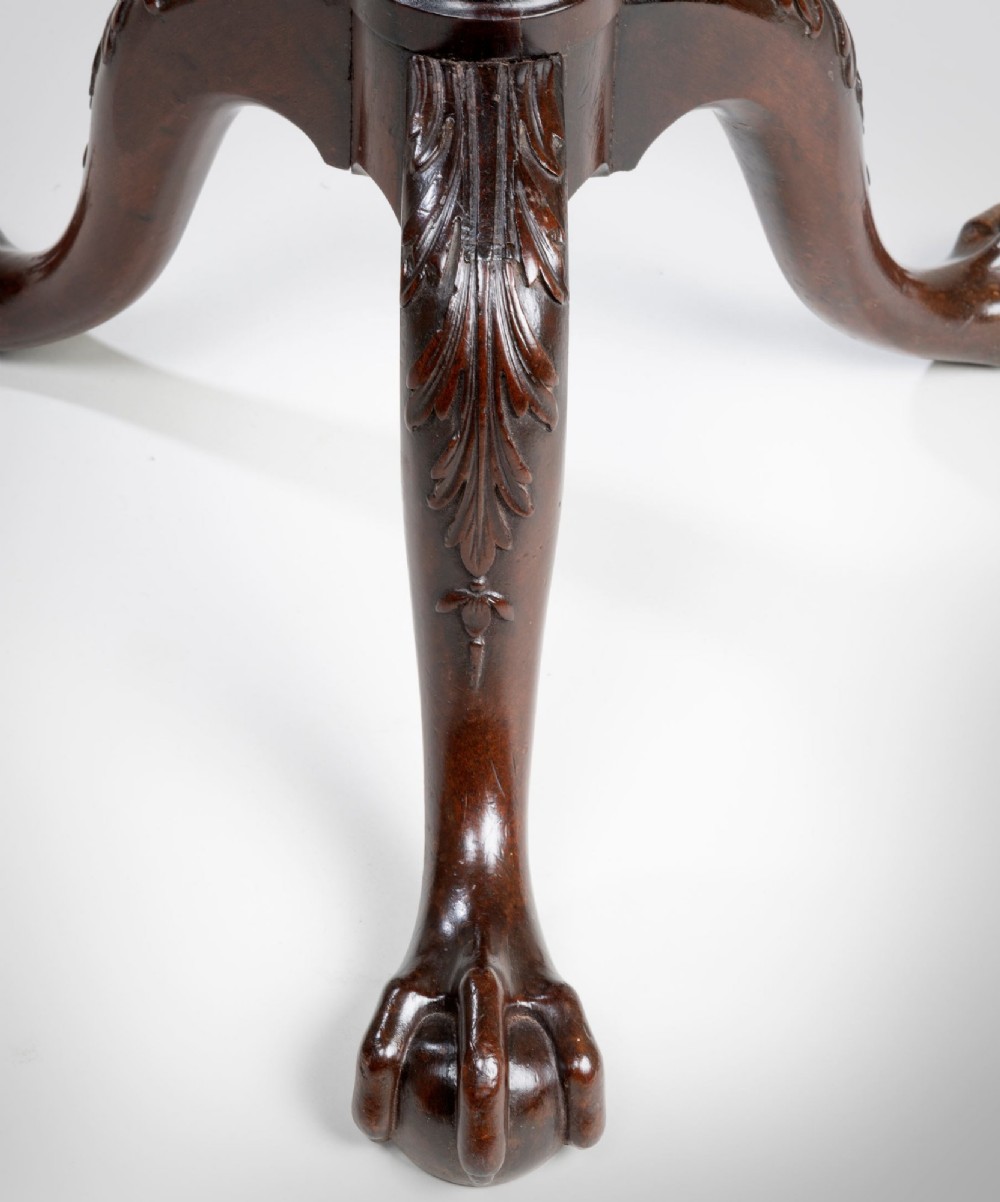 A tall Georgian mahogany torchere featuring a molded dish top, fluted central column, and carved tripod cabriole legs terminating in claw and ball feet. View II