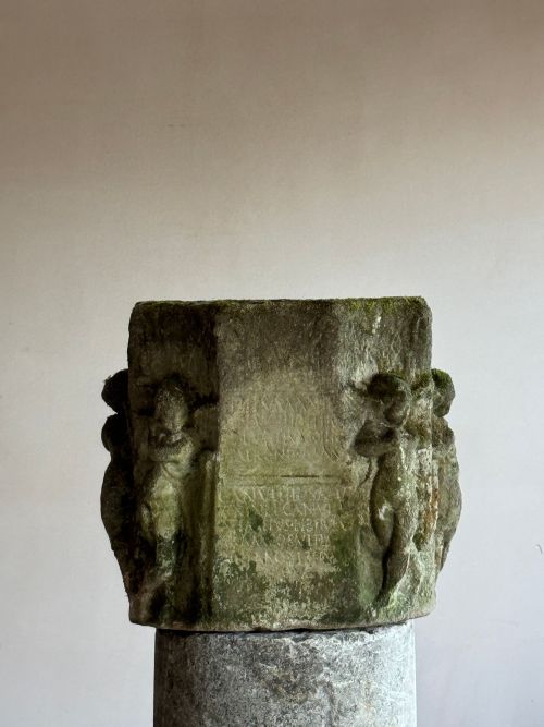 A CAST STONE ROMAN FUNERARY ALTAR