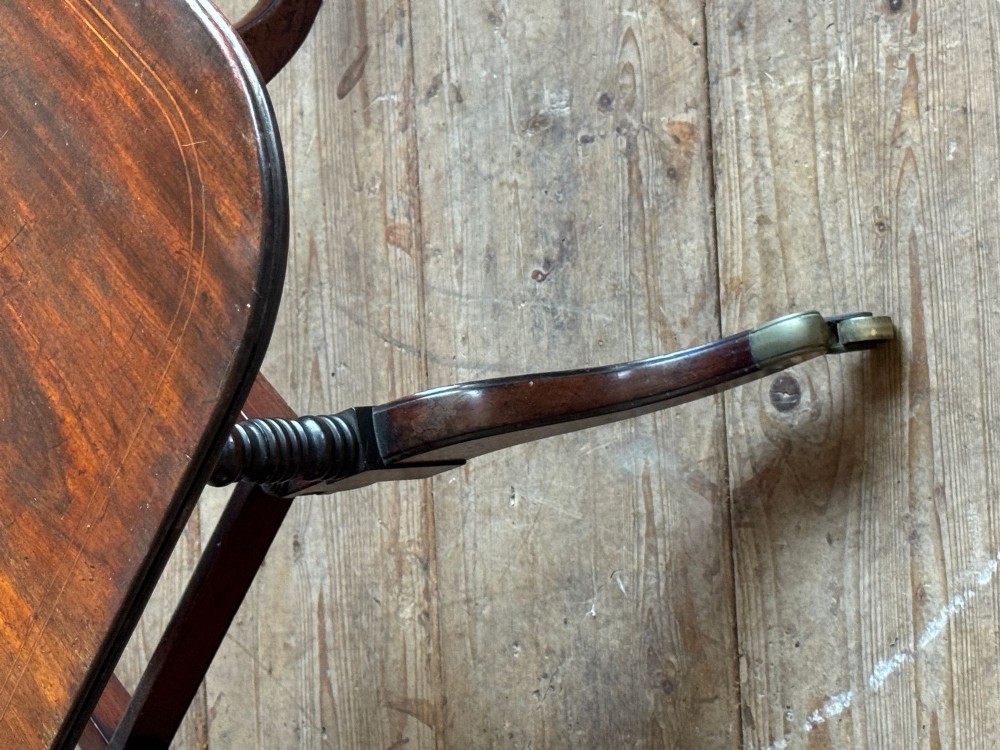 A dark mahogany Georgian Cumberland drop-leaf dining table with bobbin-turned dual legs, splayed feet, and brass castors. View VIII
